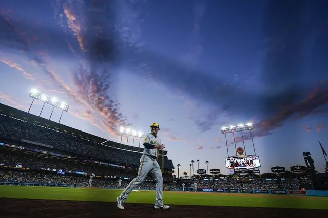Milwaukee Brewers right fielder Tyrone Taylor talks takes to the field during the third inning of a baseball game against the Los Angeles Dodgers, Tuesday, August 15, 2023, in Los Angeles. (Photo by Ryan Sun/AP Photo)