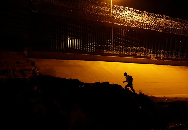 A migrant are seen after crossing the Rio Bravo river to turn himself in to U.S. Border Patrol agents to request for asylum in El Paso, Texas, U.S., as seen from Ciudad Juarez, Mexico March 19, 2021. (Photo by Jose Luis Gonzalez/Reuters)