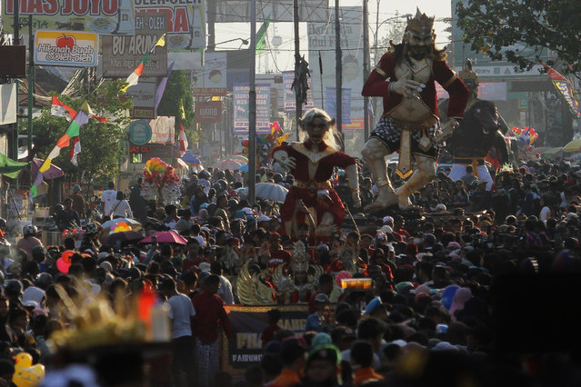 People carry “Ogoh-ogoh”, sculptural works of art in Balinese culture when they attend a carnival during the Saparan Bekakak Tradition event in Sleman, Yogyakarta, Indonesia on September 1, 2023. The cultural carnival was closed with the “Bekakak” slaughtering procession which was manifested in the form of a bride and groom named “Tirto Dono Jati” and “Tirto Nyi Mayangsari” made from a mixture of rice flour and glutinous rice flour to ask for the safety of residents to avoid disasters. (Photo by Angga Budhiyanto/ZUMA Press Wire/Rex Features/Shutterstock)