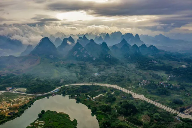Aerial photo taken on May 21, 2020 shows a view of Huanjiang Maonan Autonomous County, south China's Guangxi Zhuang Autonomous Region. The Maonan ethnic group is one of the country's 28 ethnic groups with a smaller population. About 70 percent of Maonan people, or 64,500, live in Huanjiang County. The poverty headcount ratio in Huanjiang dropped to 1.48 percent by the end of last year. The county was removed from the country's list of impoverished counties this month. Based on the Maonan people's poverty alleviation situation across the country, the ethnic group has gotten rid of poverty as a whole. (Photo by Xinhua News Agency/Rex Features/Shutterstock)
