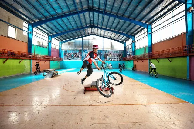 Asghar Mehrzada, 26, the founder of “Drop and Ride freestyle cycling club” shows his tricks during an exercise in Kabul, Afghanistan, 29 June 2021. Drop and Ride Club is Afghanistan's first freestyle cycling club that stands for “Drop the Gun and Ride a Bike”. The club has 60 members, of whom 25 are female, and gathers three times a week to practice at a gymnasium in the capital, using metal tables, wooden crates and boxes to perfect stunts they have seen performed on YouTube, Facebook, and other social media. In Afghanistan, cycling is a major taboo for girls, and often viewed as a sin, but some girls dared to join the freestyle cycling club. (Photo by Hedayatullah Amid/EPA/EFE)