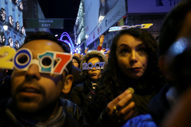 Revellers wait for the clock to strike midnight during New Year's celebrations at Puerta del Sol square in central Madrid, Spain December 31, 2016. (Photo by Susana Vera/Reuters)