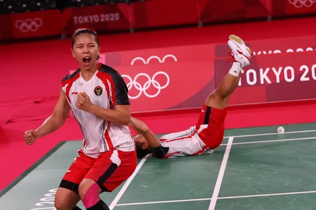 Greysia Polii (front) and Apriyani Rahayu of Indonesia react after winning the women's badminton doubles gold medal match against China at the Tokyo Olympics on August 2, 2021, at Musashino Forest Sport Plaza. (Photo by Leonhard Foeger/Reuters)