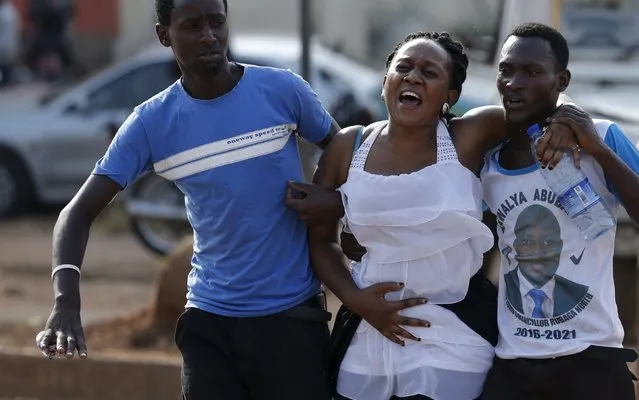 A female opposition supporter screams in pain in Kampala, Uganda February 15, 2016. (Photo by Goran Tomasevic/Reuters)