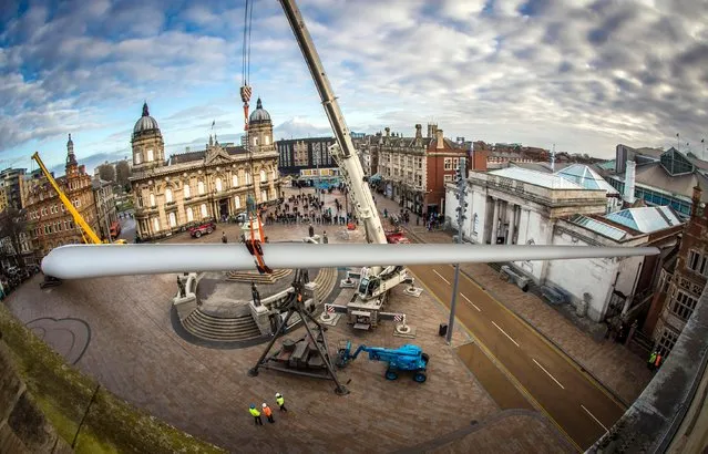 A 250ft-long (75m) wind turbine blade, which forms a new sculpture commissioned by multimedia artist Nayan Kulkarni called “Blade” is installed at Queen Victoria Square in Hull on January 8, 2017 in Hull, England. The giant wind turbine blade, one of the first made by workers at the new Siemens factory in Hull, will be on show in Queen Victoria Square and is the first in a series of major commissions by different artists that will appear in a variety of locations as part of Look Up, a year-long programme developed as part of Hull UK City of Culture 2017. (Photo by PA Wire)