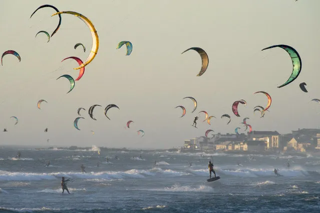 Kitesurfers kitesurf in good wind and weather on February 6, 2019, in Tableview, about 15km from the centre of Cape Town. (Photo by Rodger Bosch/AFP Photo)
