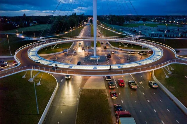 To address traffic congestion, a city in the Netherlands called Einhoven is using circular logic. An elevated 360-degree circuit, suspended by cables and stabilized by counterweights, is helping 5,000 bicyclists a day bypass roads used by 25,000 cars. The result? A bottleneck reduction for all. (Photo by Chris Keulen/National Geographic)