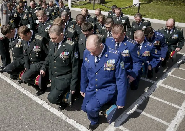 Ukrainian Air Force (R) and army officers attend a graduation ceremony at the National University of Defence of Ukraine in Kiev April 24, 2015. (Photo by Gleb Garanich/Reuters)