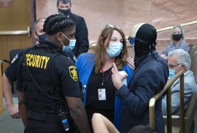 Clark County Commission Chairwoman Marilyn Kirkpatrick, center, talks a man who had refused to keep his mask on during a commission meeting at the Clark County Government Center Tuesday, September 21, 2021. (Photo by Ricardo Torres-Cortez/Las Vegas Sun via AP Photo)