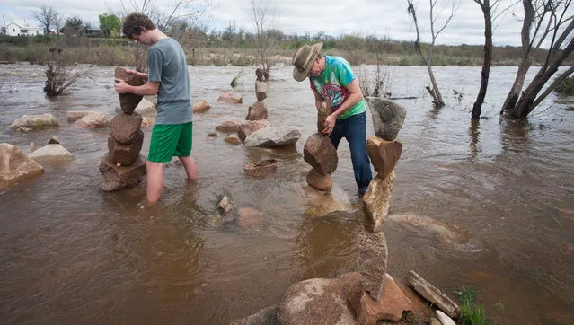 Randall McGehee, (cq) right, and his son James from Noonday, TX spent the night to take advantage of the weekend Llano Earth Art Fest. Randall has been stacking rocks for 20 years and taught his sons the art, Saturday March 12, 2016. (Photo by Nell Carroll/American-Statesman)