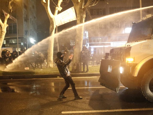 A Turkish protester stands in front of a riot police's water cannon vehicle during a demonstration in Istanbul. (Photo by Sedat Suna/EPA)