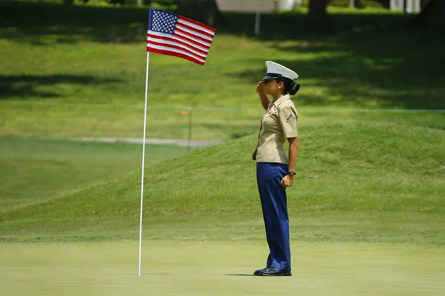 Pfc. Esmeralda Calderon stands and salutes the flag on the 15th green during the first round of the LPGA golf tournament at Kingsmill Resort and Golf Course in Williamsburg, Va., Thursday May 23, 2019. Pfc. Calderon, from San Antonio, Texas, is a Marine assigned to Naval Weapons Station Yorktown. (Photo by John Sudbrink/The Daily Press via AP Photo)