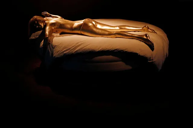A mannequin of the woman painted gold in the James Bond film “Goldfinger” is displayed during a press presentation of the exhibition “The Designing 007: Fifty Years of Bond Style” at the Grande Halle de la Villette in Paris, France, April 13, 2016. (Photo by Benoit Tessier/Reuters)