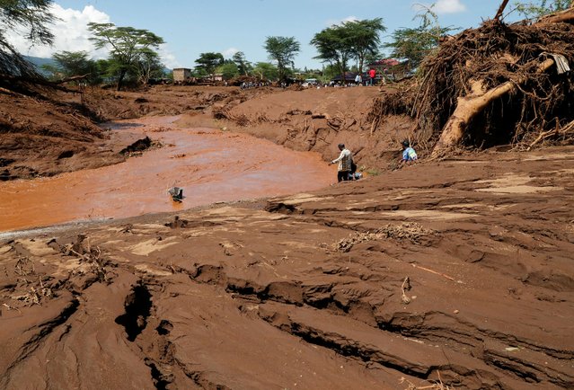 Residents gather at the riverbed as they search for missing people after heavy flash floods wiped out several homes when a dam burst, following heavy rains in Kamuchiri village of Mai Mahiu, Nakuru County, Kenya on April 29, 2024. (Photo by Thomas Mukoya/Reuters)