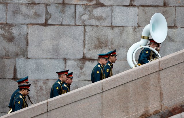 Members of a Russian military band walk upstairs before a rehearsal for a parade, which marks the anniversary of the victory over Nazi Germany in World War Two, in central Moscow, Russia, on May 5, 2024. (Photo by Shamil Zhumatov/Reuters)