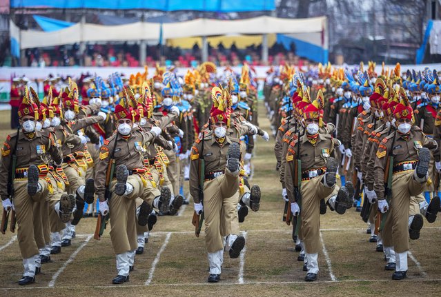 Indian soldiers and policemen wearing masks march during full dress rehearsal for the Republic Day parade in Srinagar, Indian controlled Kashmir, Monday, January 24, 2022. India celebrates Republic Day on Jan. 26. (Photo by Mukhtar Khan/AP Photo)
