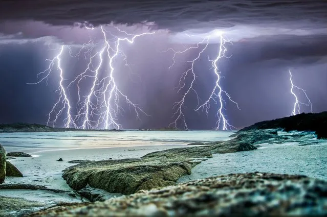A thrill-seeking storm chaser captured the precise moment these giant lightning bolts lit up dark skies in a series of incredible storms. (Photo by Caters News)