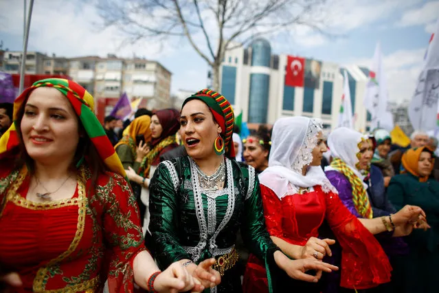 People gesture during a gathering celebrating Newroz in Istanbul, Turkey on March 21, 2017. (Photo by Osman Orsal/Reuters)
