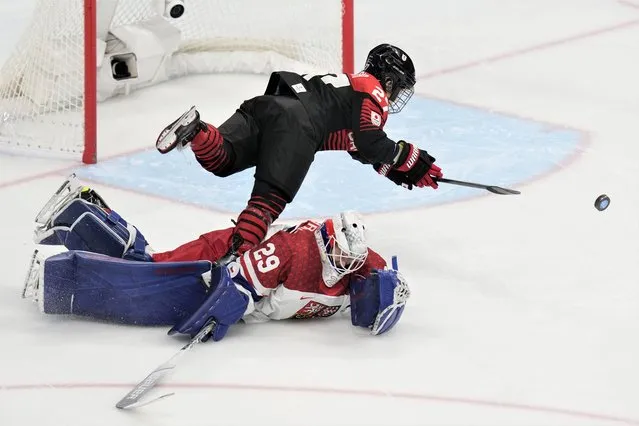 Japan's Remi Koyama (27) flips over Czech Republic goalkeeper Klara Peslarova (29) during a failed shoot-out attempt during a preliminary round women's hockey game at the 2022 Winter Olympics, Tuesday, February 8, 2022, in Beijing. (Photo by Petr David Josek/AP Photo)