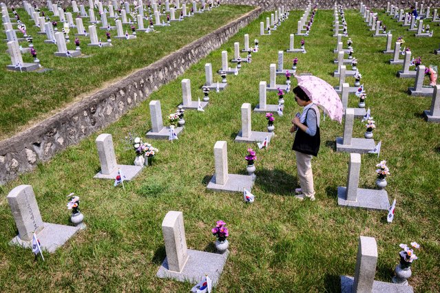 A woman visits a grave at the National Cemetery as South Korea marks Memorial Day, which honours those who died during the 1950-53 Korean War and in other operations while serving their country, in Seoul on June 6, 2024. (Photo by Anthony Wallace/AFP Photo)