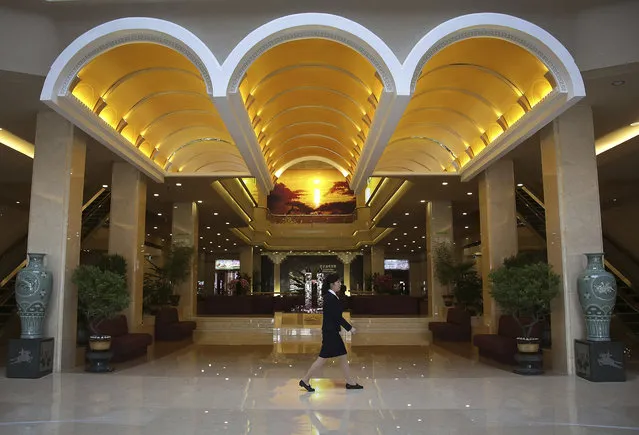 In this Monday, April 10, 2017, photo, a staff member of the newly renovated Koryo hotel walks across its main lobby in Pyongyang, North Korea. The country's most famous luxury hotel reopened this week after renovations. With its twin towers in the center of the city, the Koryo has for decades been one of Pyongyang's best-known and most visible landmarks. (Photo by Wong Maye-E/AP Photo)