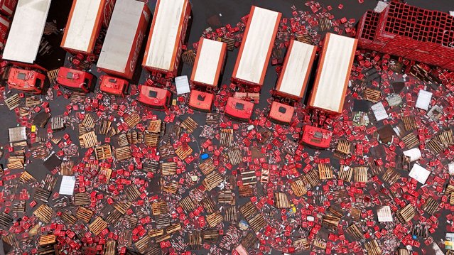 A drone view shows Coca-Cola FEMSA boxes and bottles floating in the water near trucks, amid flooding in Porto Alegre, Rio Grande do Sul state, Brazil, on May 19, 2024. (Photo by Amanda Perobelli/Reuters)