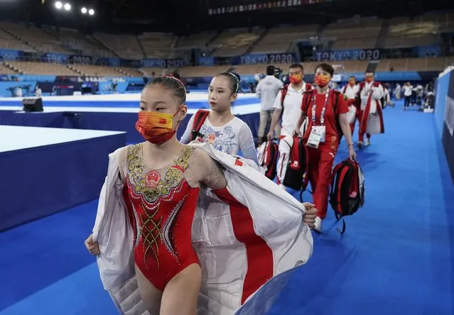 In this July 25, 2021, file photo, members of team China walk to the next apparatus during the women's artistic gymnastic qualifications at the 2020 Summer Olympics in Tokyo. Tokyo Olympians are exercising extraordinary discipline against the coronavirus. They are sealed off in a sanitary bubble that has made competition possible but is also squeezing a lot of fun from their Olympic experience. (Photo by Ashley Landis/AP Photo/File)