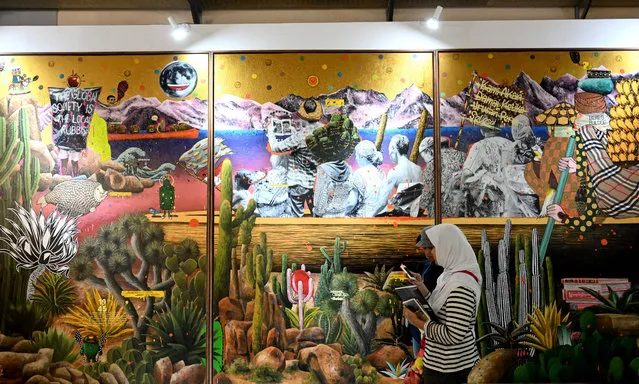 A woman visits the annual contemporary art fair “Art Jakarta 2019” in Jakarta, Indonesia on September 1, 2019. The art festival feature some 70 galleries comprising of 40 international and 30 local galleries. (Photo by Goh Chai Hin/AFP Photo)