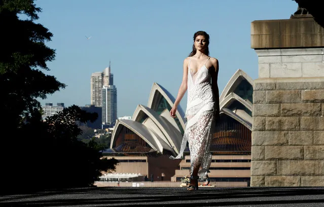 A model walks past the Sydney Opera House during the Manning Cartel show under the Sydney Harbour Bridge during Australian Fashion week, May 17, 2016. (Photo by Jason Reed/Reuters)