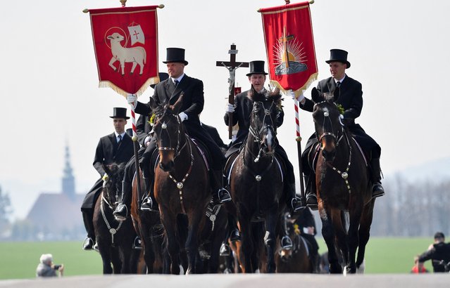 Men of Slavic ethnic minority of Sorbs dressed in black tailcoats, ride decorated horses during an Easter rider procession near Panschwitz, Germany on April 9, 2023. (Photo by Matthias Rietschel/Reuters)