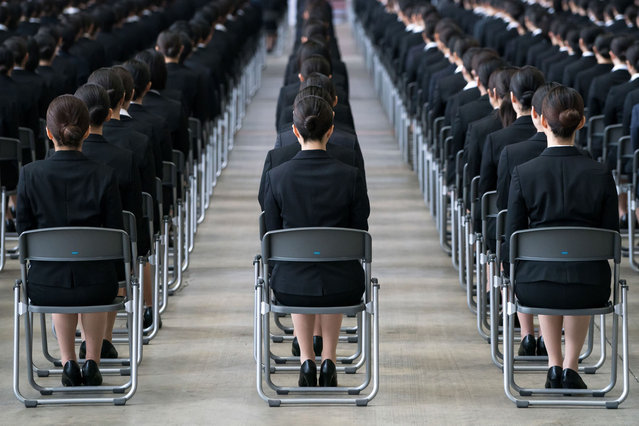 Newly hired employees for Japan Airlines (JAL) attend an entrance ceremony in a hangar at Haneda Airport on April 03, 2023 in Tokyo, Japan. 2,000 new employees from 37 JAL group companies were welcomed at the event held for the first time in four years following a hiatus due to the coronavirus pandemic. (Photo by Tomohiro Ohsumi/Getty Images)