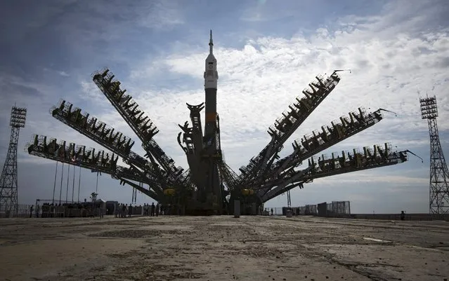 Multiple exposure picture of service towers moving towards the Soyuz TMA-17M spacecraft lifted on its launch pad at the Baikonur cosmodrome, Kazakhstan, July 20, 2015. (Photo by Shamil Zhumatov/Reuters)