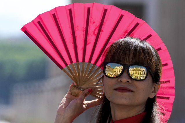 St. Peter's Basilica is reflected in a woman's glasses as she attends a mass presided by Pope Francis for the World Children Day, in St.Peter's Square at the Vatican, Sunday, May 26, 2024. (Photo by Gregorio Borgia/AP Photo)