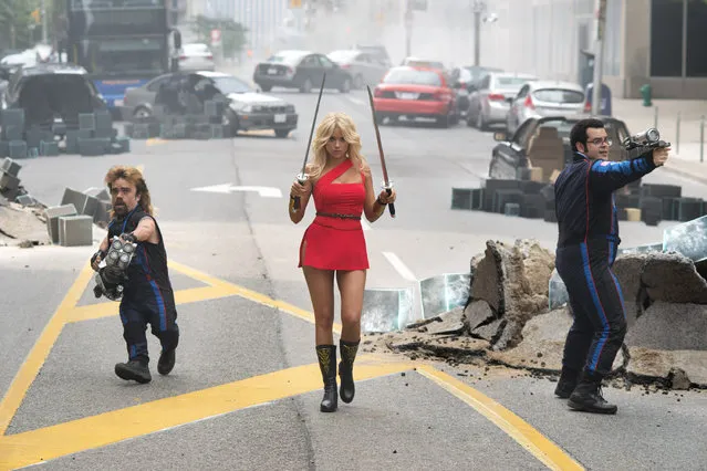 This photo provided by courtesy of Sony Pictures shows, Peter Dinklage, from left, as Eddie, Ashley Benson as Lady Lisa, and Josh Gad as Ludlow, on the streets of Washington, D.C. in Columbia Pictures' “Pixels”. The movie opens in U.S. theaters on July 24, 2015. (Photo by George Kraychyk/Sony Pictures via AP Photo)