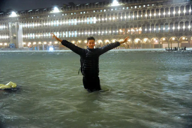 A man stands in an over flooded St. Mark's Square late Tuesday, November 12, 2019. The high-water mark hit 187 centimeters (74 inches) late Tuesday, meaning more than 85% of the city was flooded. The highest level ever recorded was 198 centimeters (78 inches) during infamous flooding in 1966. (Photo by Andrea Merola/ANSA via AP Photo)