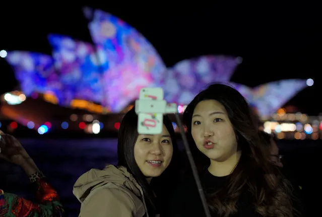 Women take a 'selfie' in front of the Sydney Opera House during the opening night of the annual Vivid Sydney light festival in Sydney, Australia May 27, 2016. (Photo by Jason Reed/Reuters)