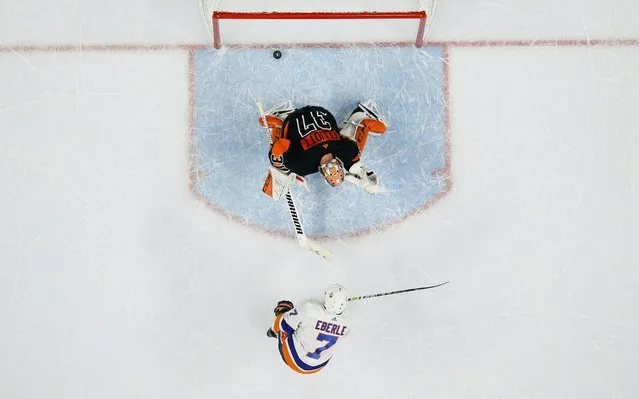 New York Islanders' Jordan Eberle (7) scores a goal past Philadelphia Flyers' Brian Elliott (37) during a shootout in an NHL hockey game, Saturday, November 16, 2019, in Philadelphia. New York won 4-3. (Photo by Matt Slocum/AP Photo)