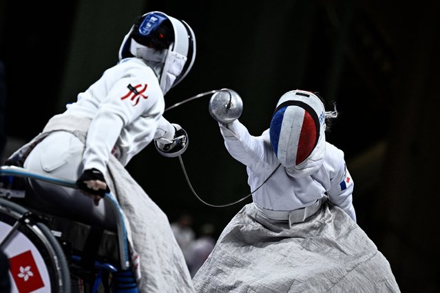 Hong Kong’s Yee Chui Yu (L) competes against France’s Clemence Delavoipiere in the wheelchair fencing women's Epee team quarter final match between France and Hong Kong during the Paris 2024 Paralympic Games at the Grand Palais in Paris on September 7, 2024. (Photo by Julien de Rosa/AFP Photo)