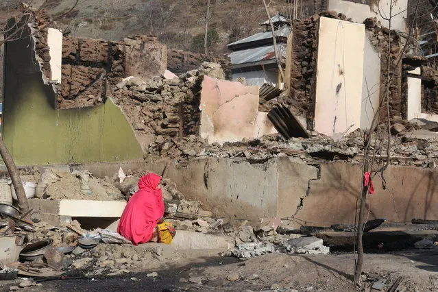 A Pakistani Kashmiri woman sits amid the debris of her home that was reportedly destroyed by cross border shelling from Indian troops, in Neelum Valley, situated at the Line of Control in Pakistani Kashmir, Monday, December 23, 2019. Pakistani authorities said Sunday that mortars fired by Indian troops into Pakistan's portion of the disputed Kashmir region have killed several civilians and damaged nearly a dozen homes in recent days. (Photo by M.D. Mughal/AP Photo)