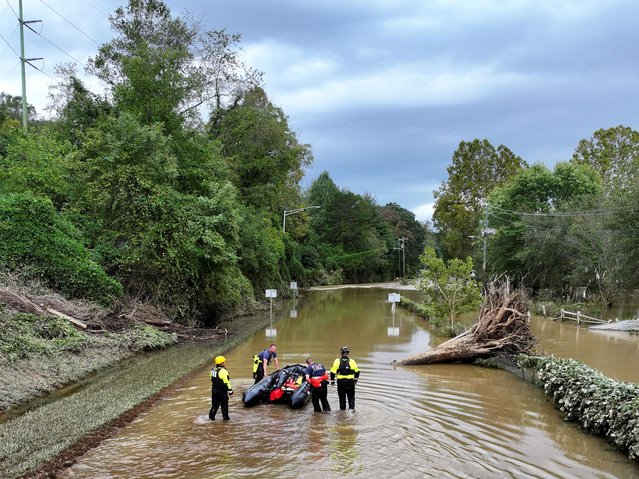 A drone view shows rescue personnel working in a flooded area, following the pass of Hurricane Helene, in Asheville, North Carolina, U.S., September 29, 2024. (Photo by Marco Bello/Reuters)