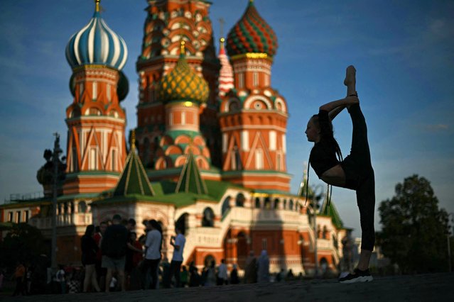 A girl poses on Red Square in front of St. Basil's Cathedral in central Moscow on September 9, 2024. (Photo by Natalia Kolesnikova/AFP Photo)