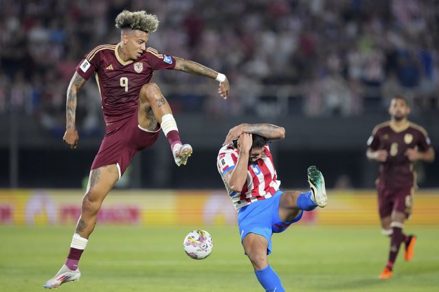 Venezuela's Jhonder Cadiz, left, and Paraguay's Omar Alderete vie for the ball during a FIFA World Cup 2026 qualifying soccer match at Defensores del Chaco Stadium in Asuncion, Paraguay, Tuesday, October 15, 2024. (Photo by Jorge Saenz/AP Photo)