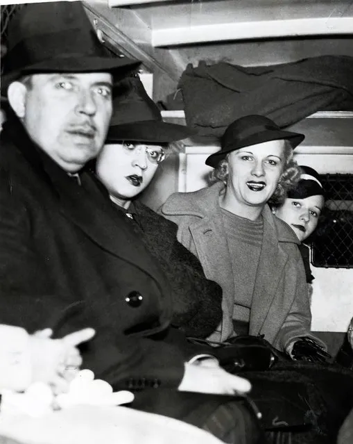 People arrested sit in back of a police wagon following a vice raid on the Rialto Theatre, October 17, 1937. Twenty-two women and 10 men were arrested in the surprise raid at the theater and charged with presenting or participating in indecent exhibitions. All arrested were released on $125 bail. In total 70 men and 45 women were arrested in the surprise raids across the city. (Photo by Chicago Tribune Historical Photo)