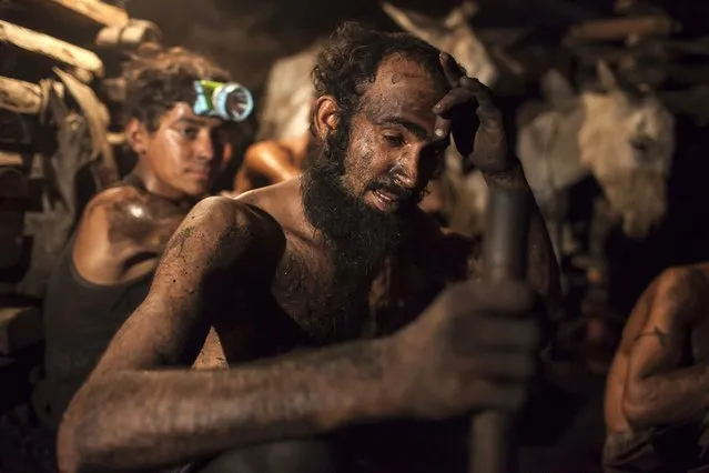 A miner wipes sweat from his forehead inside a coal mine in Choa Saidan Shah, Punjab province, April 29, 2014. (Photo by Sara Farid/Reuters)