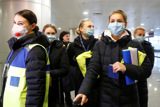 Ukraine International Airlines crew members wear protective masks while taking safety precautions amid concerns over coronavirus upon their arrival at the Boryspil International Airport outside Kiev, Ukraine on February 4, 2020. (Photo by Valentyn Ogirenko/Reuters)