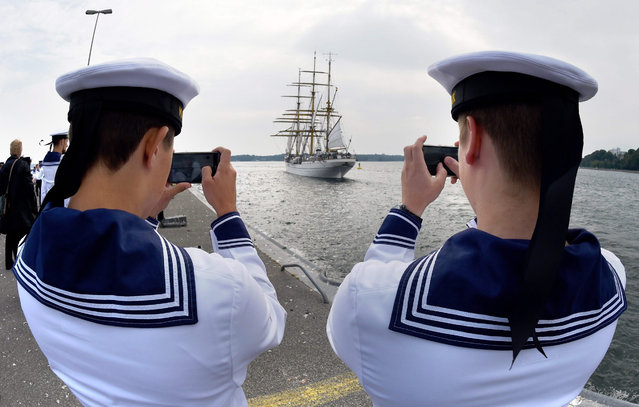 Marines of the Gorch Fock tall ship as it sets sail in Kiel, Germany, 24 August 2015. The school ship of the German navy holds course for Ireland at first and is expected back in Kiel in the summer of 2016. (Photo by Carsten Rehder/EPA)