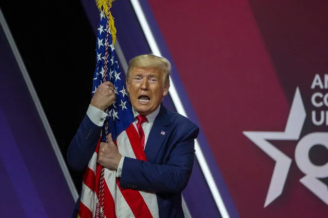 President Donald Trump hugs the flag of the United States of America at the annual Conservative Political Action Conference (CPAC) at Gaylord National Resort & Convention Center February 29, 2020 in National Harbor, Maryland. Conservatives gather at the annual event to discuss their agenda. (Photo by Tasos Katopodis/Getty Images)