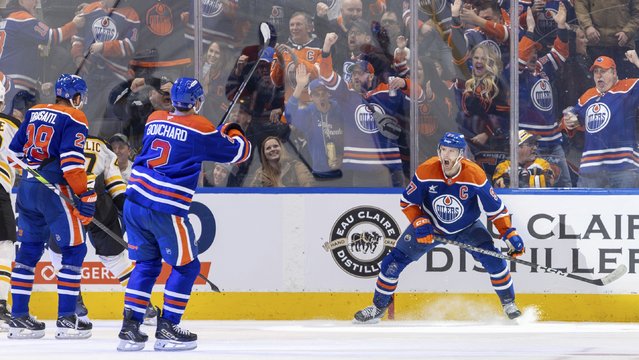 Edmonton Oilers' Connor McDavid (97) celebrates his goal against the Boston Bruins with Evan Bouchard (2) and Leon Draisaitl (29) during the third period of an NHL hockey game in Edmonton, Alberta, Thursday, December 19, 2024. (Photo by Timothy Matwey/The Canadian Press via AP Photo)