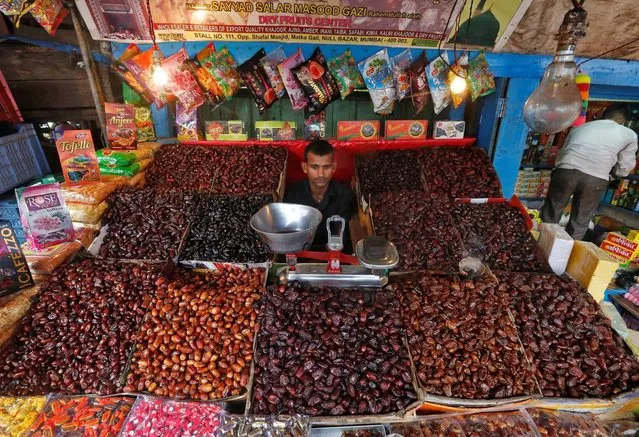A vendor selling dates and candy waits for customers at a market in Mumbai, India, July 25, 2016. (Photo by Shailesh Andrade/Reuters)