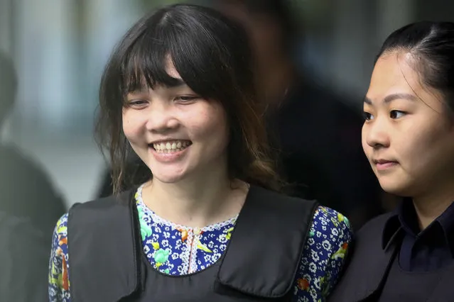 Vietnamese Doan Thi Huong, left, is escorted by police as she leaves after the court hearing at the Shah Alam court house in Shah Alam court house in Shah Alam, outside Kuala Lumpur, Malaysia Wednesday, October 11, 2017. Security videos were presented at the murder trial Wednesday showing the estranged half brother of North Korea's leader being attacked at a Malaysian airport and the two suspects hurrying away afterward. (Photo by Sadiq Asyraf/AP Photo)
